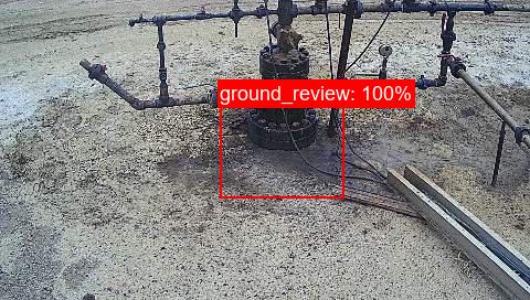 AI detecting a potential oil leak on the ground, highlighted with a 100% confidence bounding box